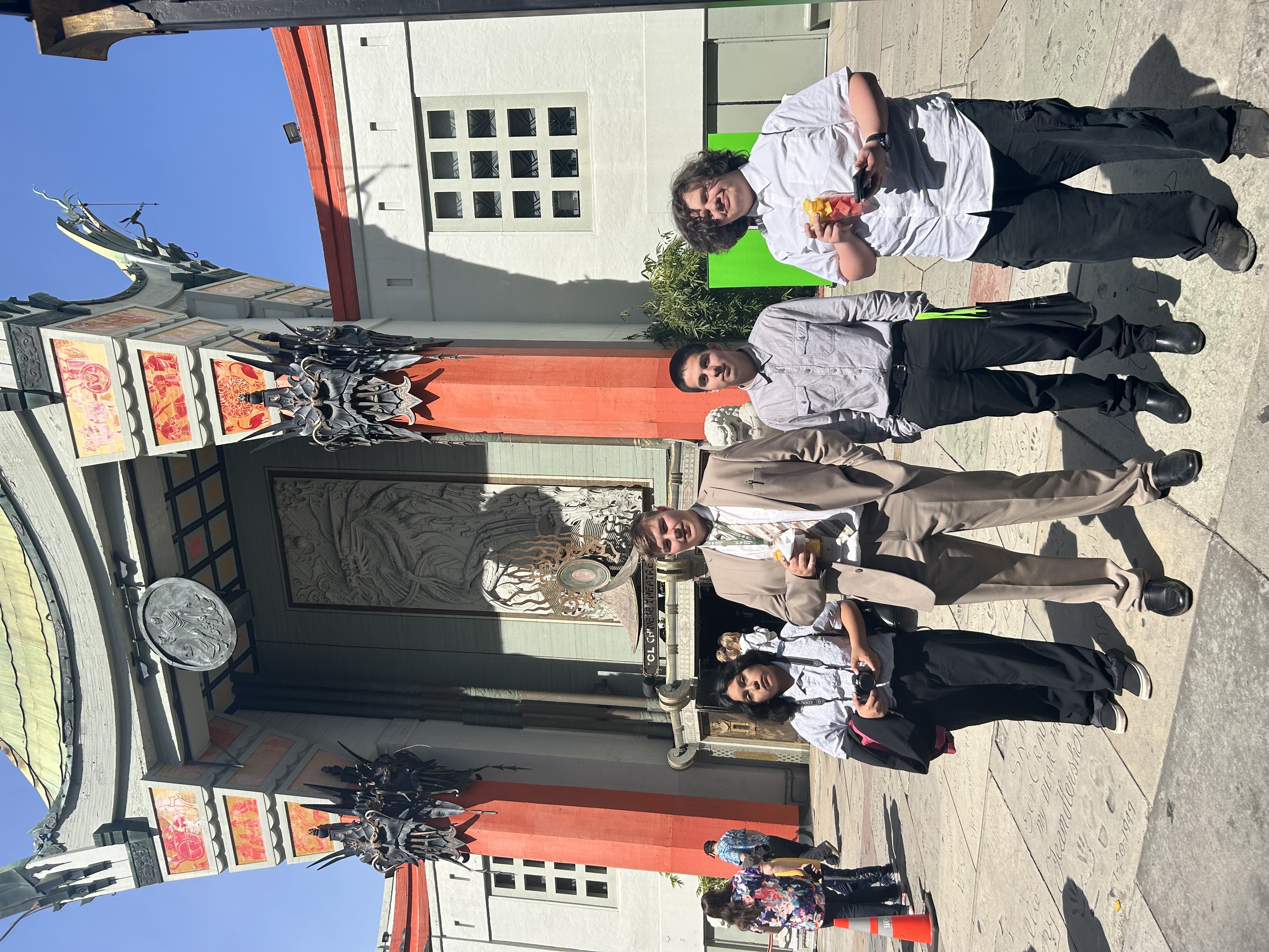 Mock trial students posing in front of huge building structure