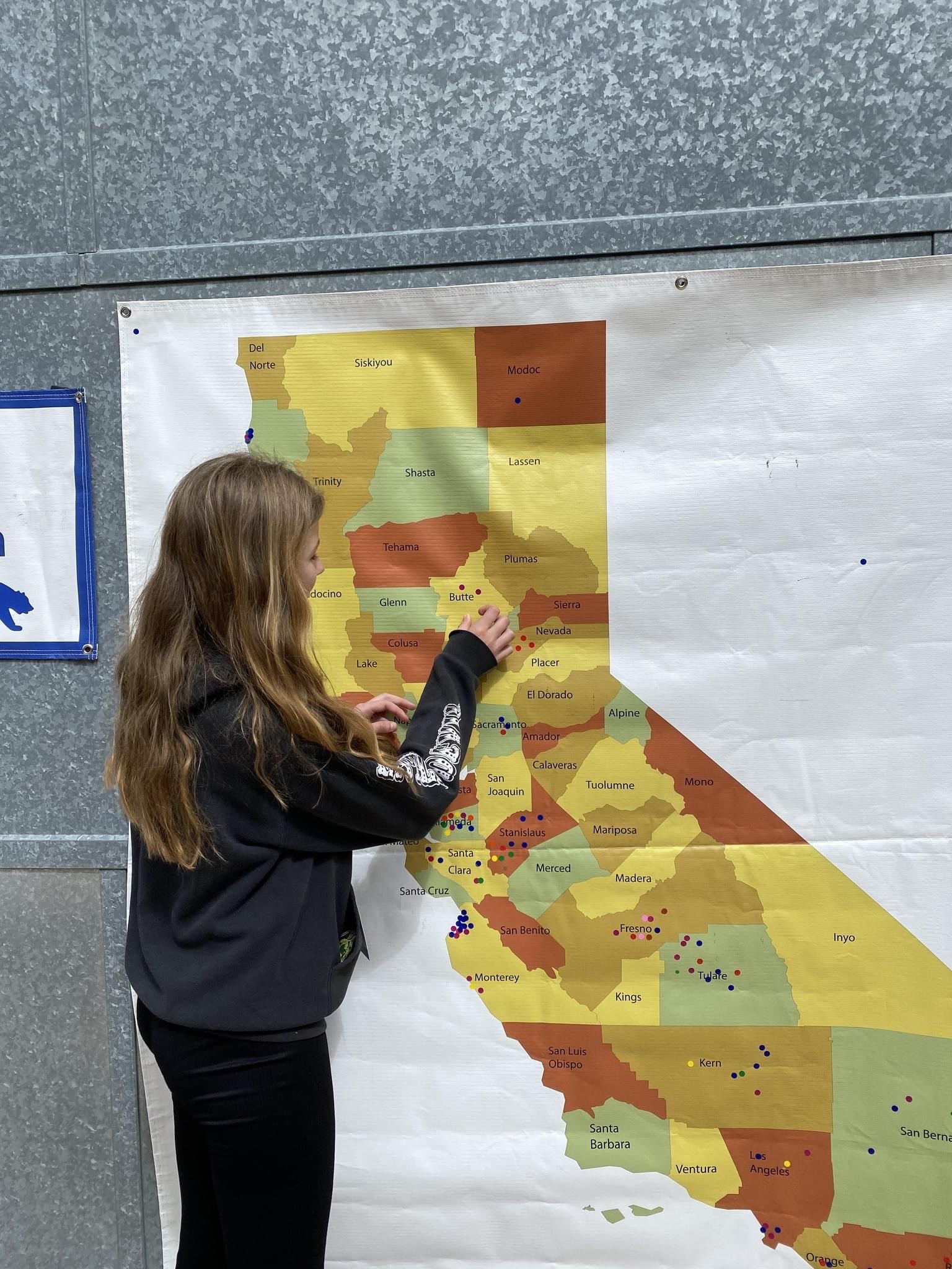 NHD student pointing at map 
