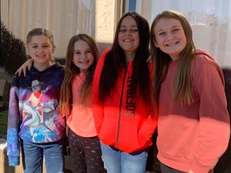 Picture of four students grouped together smiling